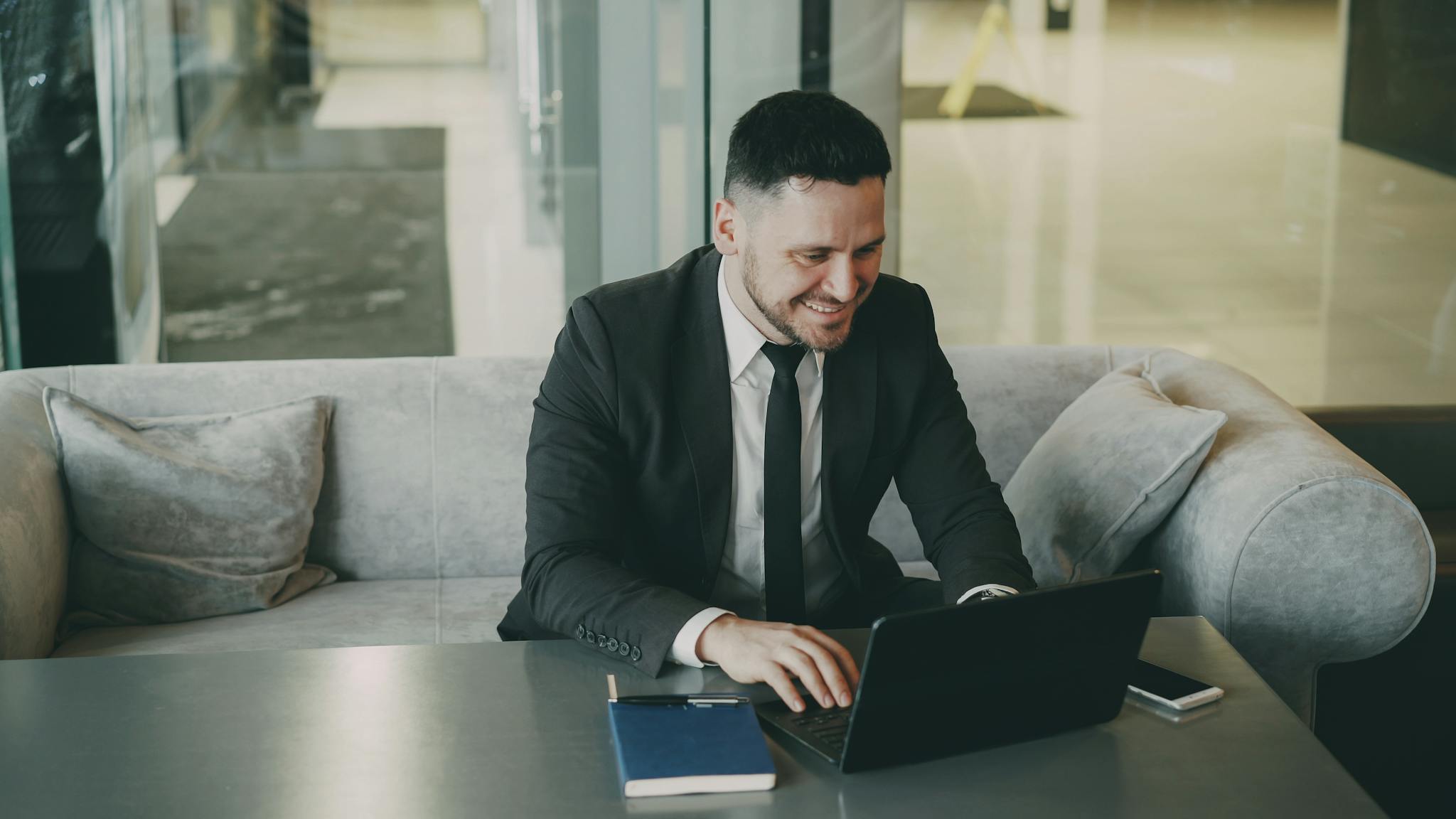 Professional man in suit using laptop at office, representing business success and workplace productivity.